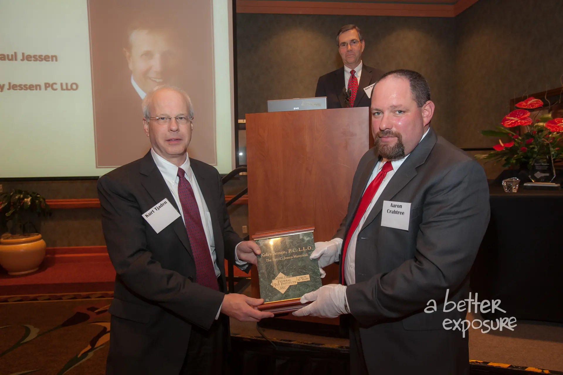President Aaron Crabtree presents Kurt Tjaden with a plaque recognizing the Paul Jessen Memorial contribution from the Koley Jes