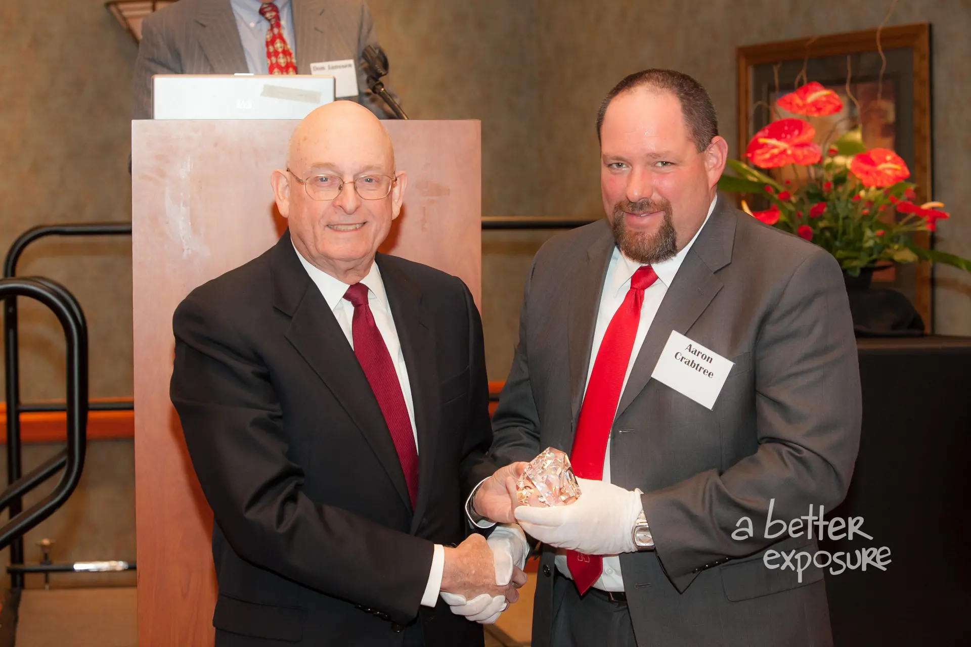 President Aaron Crabree presents Larry Gibbs with a gift from the Great Plains Federal Tax Institute
